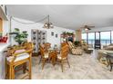 Comfortable living room with tile flooring, stylish seating, and sliding glass doors to the balcony with ocean views at 15000 Gulf Blvd # 407, Madeira Beach, FL 33708
