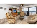 Cozy living room features comfortable seating, a large window with ocean views, and a ceiling fan at 15000 Gulf Blvd # 407, Madeira Beach, FL 33708