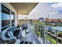 Relax on this balcony with outdoor seating and tranquil views of the marina and boats at 1621 Gulf Blvd # 407, Clearwater Beach, FL 33767