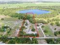 Expansive property featuring a home and a picturesque lake nearby at 17023 Alderman Turner Rd, Wimauma, FL 33598