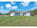 Well-kept home featuring an attached garage and spacious front yard at 17023 Alderman Turner Rd, Wimauma, FL 33598