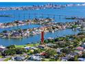 Expansive waterfront property with lush landscaping and a stunning aerial view showcasing the surrounding waterways and city skyline at 224 Harbor View Ln, Largo, FL 33770