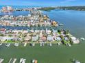 Stunning aerial view of waterfront homes, canals, and Tampa Bay in the distance at 241 176Th Terrace E Dr, Redington Shores, FL 33708