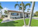 Beautiful single-story home with a landscaped yard and paver walkway at 241 176Th Terrace E Dr, Redington Shores, FL 33708