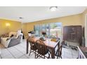 Open dining area featuring tile floors, a wooden table with chairs, and natural light from sliding glass doors at 306 Brandywine Dr, Valrico, FL 33594