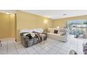 Bright living room featuring tile flooring, with comfortable seating and a sunny window at 306 Brandywine Dr, Valrico, FL 33594