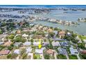 Stunning aerial view showcases this waterfront home nestled among other homes, canals, and open ocean at 308 Cedar Ln, Largo, FL 33770