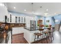 Spacious kitchen with stainless steel appliances and a large island with bar stools at 3503 W Price Ave, Tampa, FL 33611