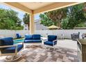 Covered patio with comfortable blue cushioned seating overlooking a pool at 3503 W Price Ave, Tampa, FL 33611