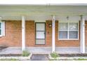 Covered front porch featuring brick columns and a decorative address number at 40019 Pretty Redbird Rd, Zephyrhills, FL 33540