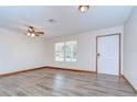Bright living room with new floors, ceiling fan, and lots of natural light at 40019 Pretty Redbird Rd, Zephyrhills, FL 33540