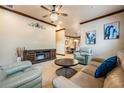 Comfortable living room boasts tile floors, ceiling fan, and entertainment center at 4400 English Turn Way, Wesley Chapel, FL 33543