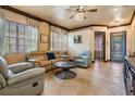Cozy living room featuring tile floors, neutral paint, ceiling fan, and comfortable seating at 4400 English Turn Way, Wesley Chapel, FL 33543