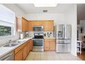 Well-lit kitchen with stainless steel appliances and ample cabinet space at 4926 Pennecott Way, Wesley Chapel, FL 33544