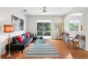 Bright living room with comfortable seating, a glass coffee table, and a view of the outdoors at 4926 Pennecott Way, Wesley Chapel, FL 33544