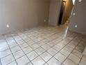 Living room featuring neutral paint and tiled floors, and a staircase leading to the bedrooms at 5042 Terrace Village Ln, Tampa, FL 33617