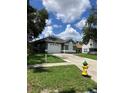 Attractive single-story home with a two-car garage and a vibrant yellow fire hydrant nearby at 6905 Summer Harbor Ln, Riverview, FL 33578