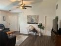 Inviting living room featuring wood floors, ceiling fan, and neutral décor with an abundance of natural light at 6905 Summer Harbor Ln, Riverview, FL 33578