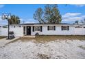 Charming single-story home with a basketball hoop and fenced yard, offering comfortable living at 8401 Pinewood St, Tampa, FL 33615