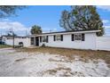 Charming single-story home with fenced yard, front entrance, and basketball hoop, providing comfort and recreation at 8401 Pinewood St, Tampa, FL 33615