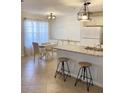 Charming kitchen features granite counters, bar stool seating, and an adjacent dining area with ample natural light at 850 S Tamiami Trl # 424, Sarasota, FL 34236