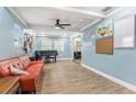 A spacious living room is brightened by a ceiling fan and features durable tile flooring at 919 Alpine Dr, Brandon, FL 33510