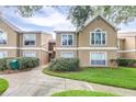 Charming exterior view of a condo complex with well-maintained grounds at 9481 Highland Oak Dr # 1504, Tampa, FL 33647