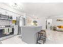 Modern condo kitchen with stainless steel appliances and a central island at 9481 Highland Oak Dr # 1504, Tampa, FL 33647