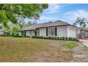 Lovely home with a brick exterior, large windows, and meticulously kept front yard at 9615 Raiden Ln, Riverview, FL 33569