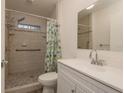 Updated bathroom featuring tiled shower and modern vanity at 10623 103Rd St, Largo, FL 33773
