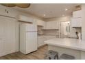 Bright kitchen featuring white cabinets, breakfast bar, and stainless steel appliances at 10623 103Rd St, Largo, FL 33773