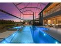 A beautiful pool and spa are surrounded by a screened enclosure with a fireplace and outdoor seating at 13019 Wildflower Meadow Dr, Riverview, FL 33579