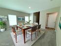Staged dining room featuring neutral tones, decorative art and pendant lighting at 13118 Zolo Springs Cir, Riverview, FL 33579