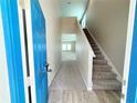 Bright foyer with carpeted stairs and views into the main living area at 13118 Zolo Springs Cir, Riverview, FL 33579