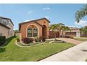 Inviting single-story home with verdant lawn and garden beds framing the house at 13128 Foxtail Fern Dr, Riverview, FL 33579