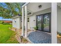Inviting front porch with decorative rug, double glass doors and pretty decorations at 1641 Jeffords St, Clearwater, FL 33756