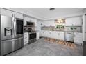 Modern kitchen featuring stainless steel appliances, granite counters, and bright white cabinets at 1641 Jeffords St, Clearwater, FL 33756