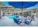 Screened-in pool area with a dining set and sun loungers providing a relaxing outdoor space at 1641 Jeffords St, Clearwater, FL 33756