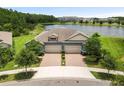 Charming single-Gathering home has well-maintained landscaping, a brick driveway and two-car garage at 16898 Balance Cv, Land O Lakes, FL 34638