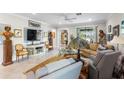 Bright living room showcasing stylish furnishings, neutral tones, and seamless flow to the outdoors at 16898 Balance Cv, Land O Lakes, FL 34638