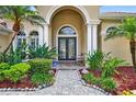 Elegant front door with sidelights, columns, and manicured landscaping at 17203 Talence Ct, Tampa, FL 33647