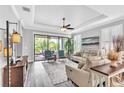 Comfortable living room with stylish furniture, a ceiling fan, and a sliding glass door at 20025 Callisto Hill Pl, Tampa, FL 33647