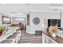 Open floor plan featuring a kitchen island, hardwood floors and modern fixtures at 20025 Callisto Hill Pl, Tampa, FL 33647