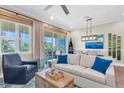 Bright living room with sliding glass doors to the balcony with tranquil outdoor view at 204 Haven Beach Ct, Indian Rocks Beach, FL 33785