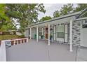 Charming home featuring a spacious front porch with decorative railing and a grey brick exterior at 215 Claire Dr, Seffner, FL 33584