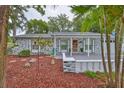 Charming home with well-manicured landscaping, front porch with a railing, and decorative touches at 215 Claire Dr, Seffner, FL 33584