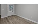 Bright entryway featuring wood-look flooring, a white door and neutral paint at 2307 N 47Th St, Tampa, FL 33605