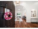 Inviting foyer with hardwood floors, a decorative wreath, and a view into the bright living space at 307 Palmetto Ln, Largo, FL 33770