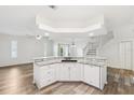 Bright kitchen with granite countertops, white cabinets, and modern appliances open to the living area at 3209 Meta Ct, Largo, FL 33771
