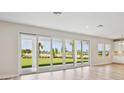 Spacious living area featuring sliding glass doors offering a scenic outdoor view and natural light at 3483 Yellow Leaf Cir, Spring Hill, FL 34609